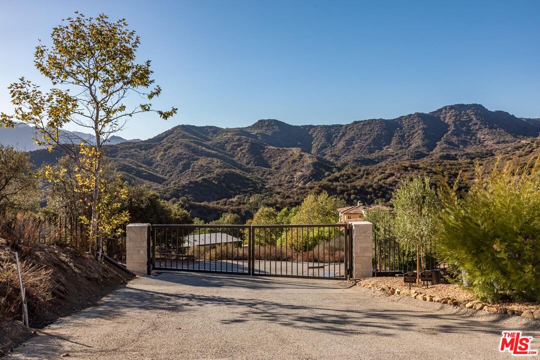 1045 Cold Canyon Road Calabasas, CA 91302 - Photo 2 of 51 a view of a fence and a mountain view
