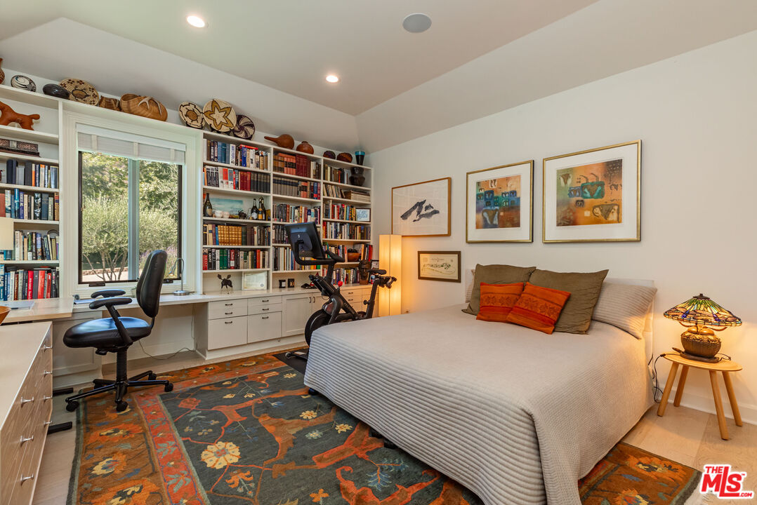 1045 Cold Canyon Road Calabasas, CA 91302 - Photo 32 of 51 a bedroom with a bed and glass door