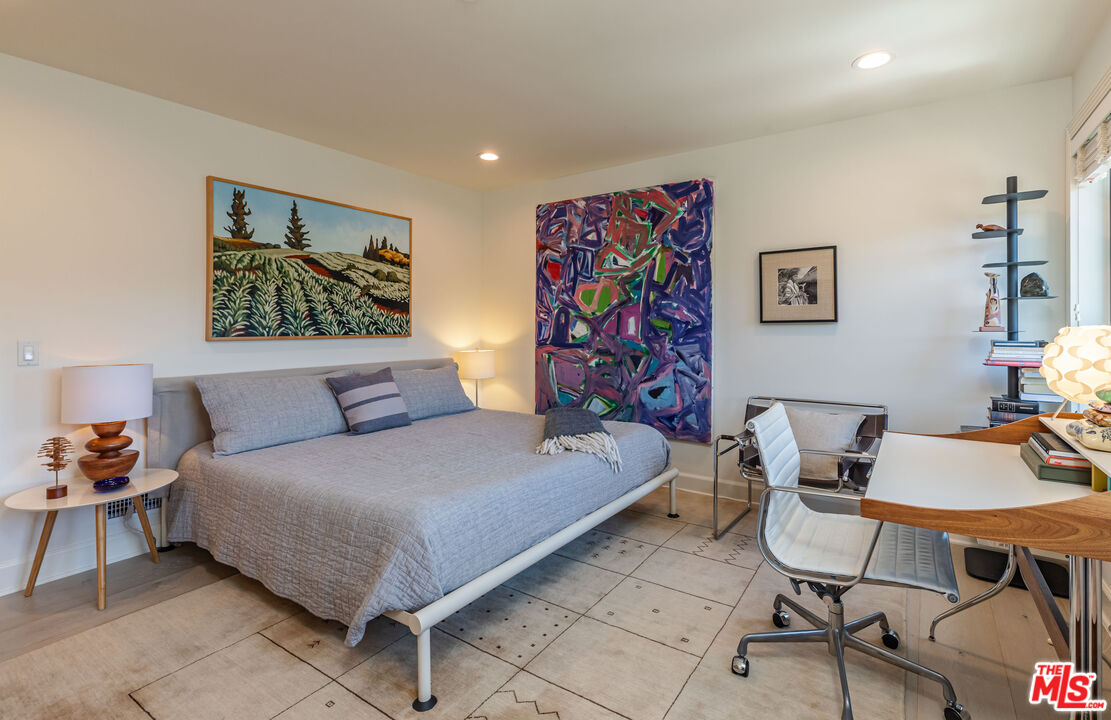 1045 Cold Canyon Road Calabasas, CA 91302 - Photo 37 of 51 a bedroom with a bed and wooden floor