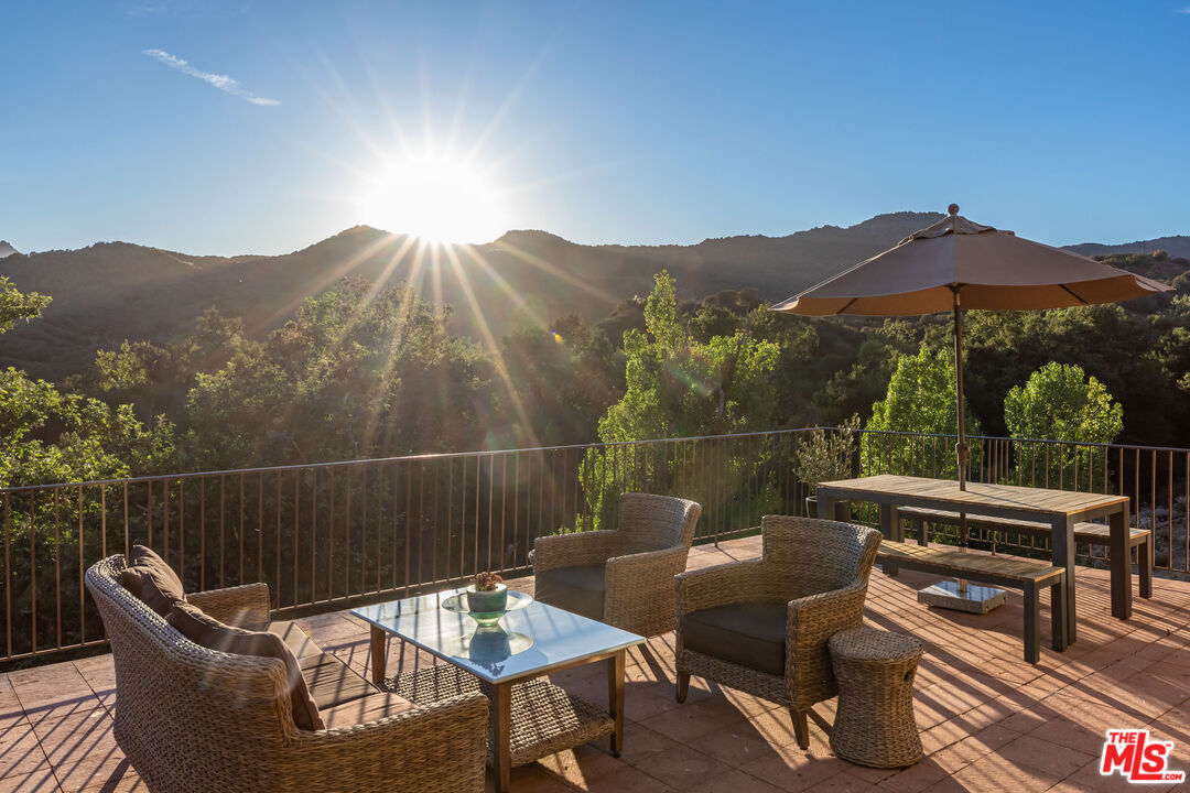 1045 Cold Canyon Road Calabasas, CA 91302 - Photo 46 of 51 a view of a chairs and table in the terrace
