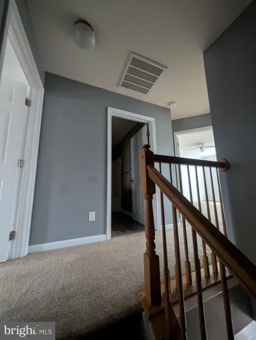 an empty room with a empty space and windows