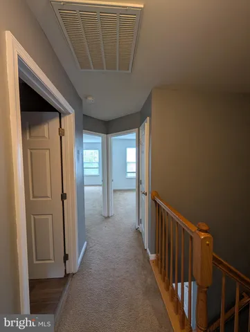 a bathroom with a sink a toilet a shower and a window