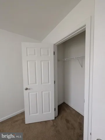 a view of hallway with wooden floor