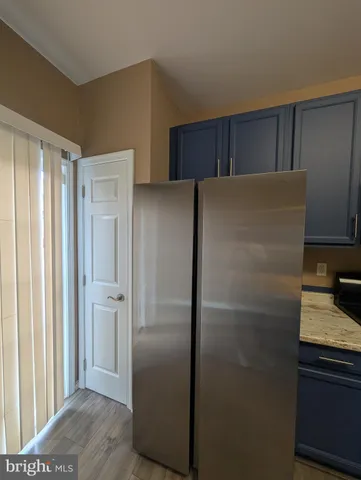 a metallic refrigerator freezer sitting in a kitchen