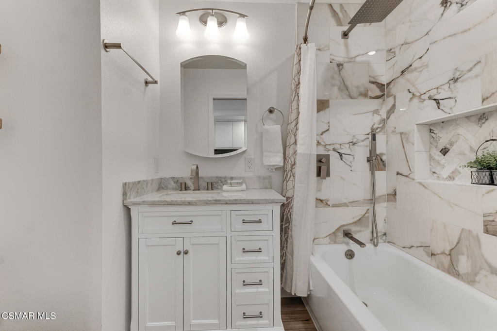 1912 Heywood Street, Unit D Simi Valley, CA 93065 - Photo 15 of 40 a bathroom with a granite countertop sink a mirror a vanity and shower
