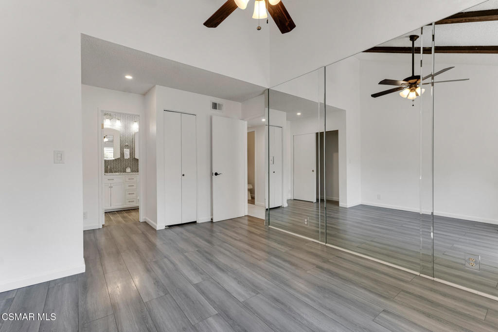1912 Heywood Street, Unit D Simi Valley, CA 93065 - Photo 19 of 40 a view of an empty room with wooden floor and a ceiling fan