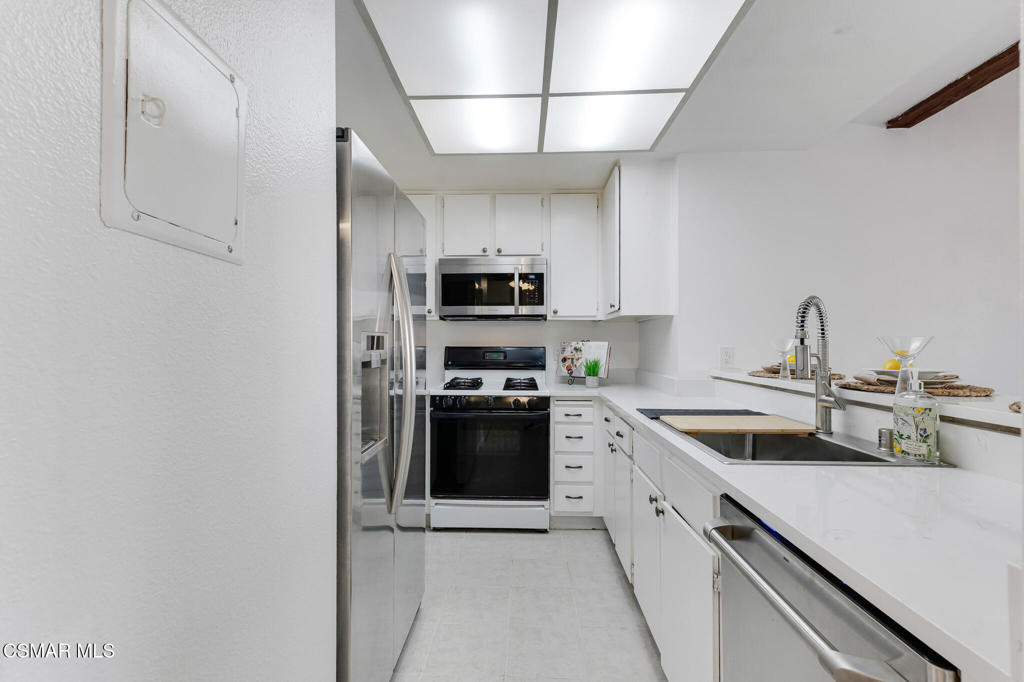 1912 Heywood Street, Unit D Simi Valley, CA 93065 - Photo 5 of 40 a kitchen with stainless steel appliances granite countertop a sink and a stove