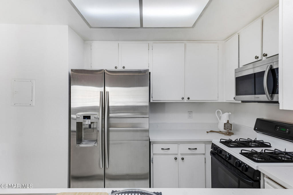 1912 Heywood Street, Unit D Simi Valley, CA 93065 - Photo 7 of 40 a kitchen with stainless steel appliances granite countertop a refrigerator and a stove
