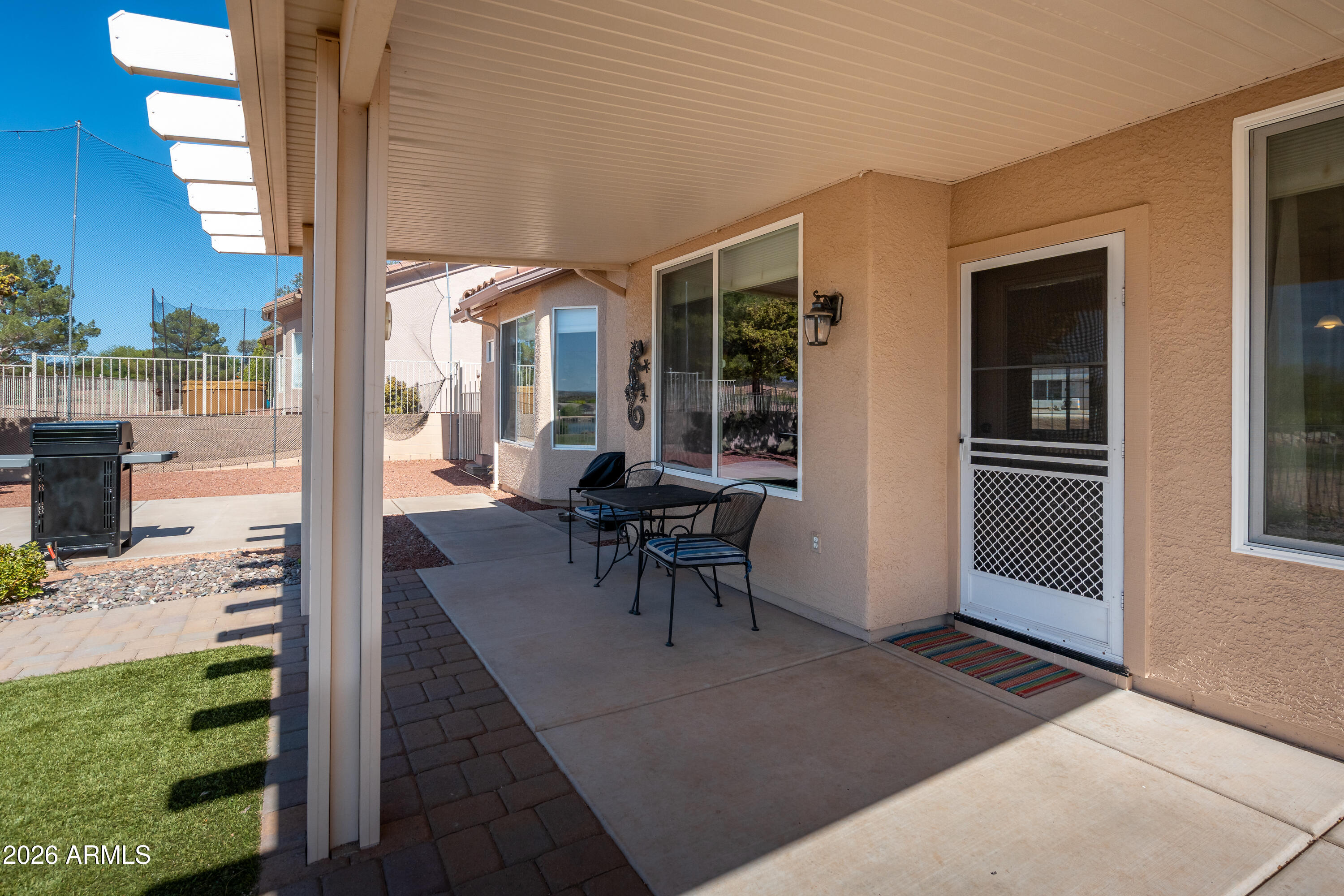 718 South Wandering River Road Cornville, AZ 86325 - Photo 31 of 41 a view of a patio with table and chairs and potted plants