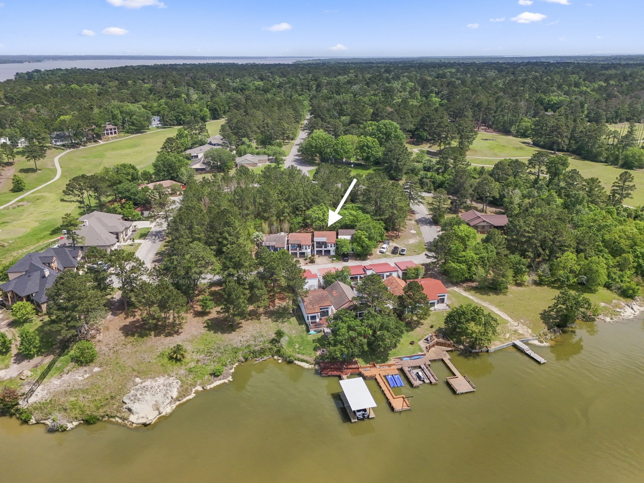 an aerial view of residential house with outdoor space and lake view