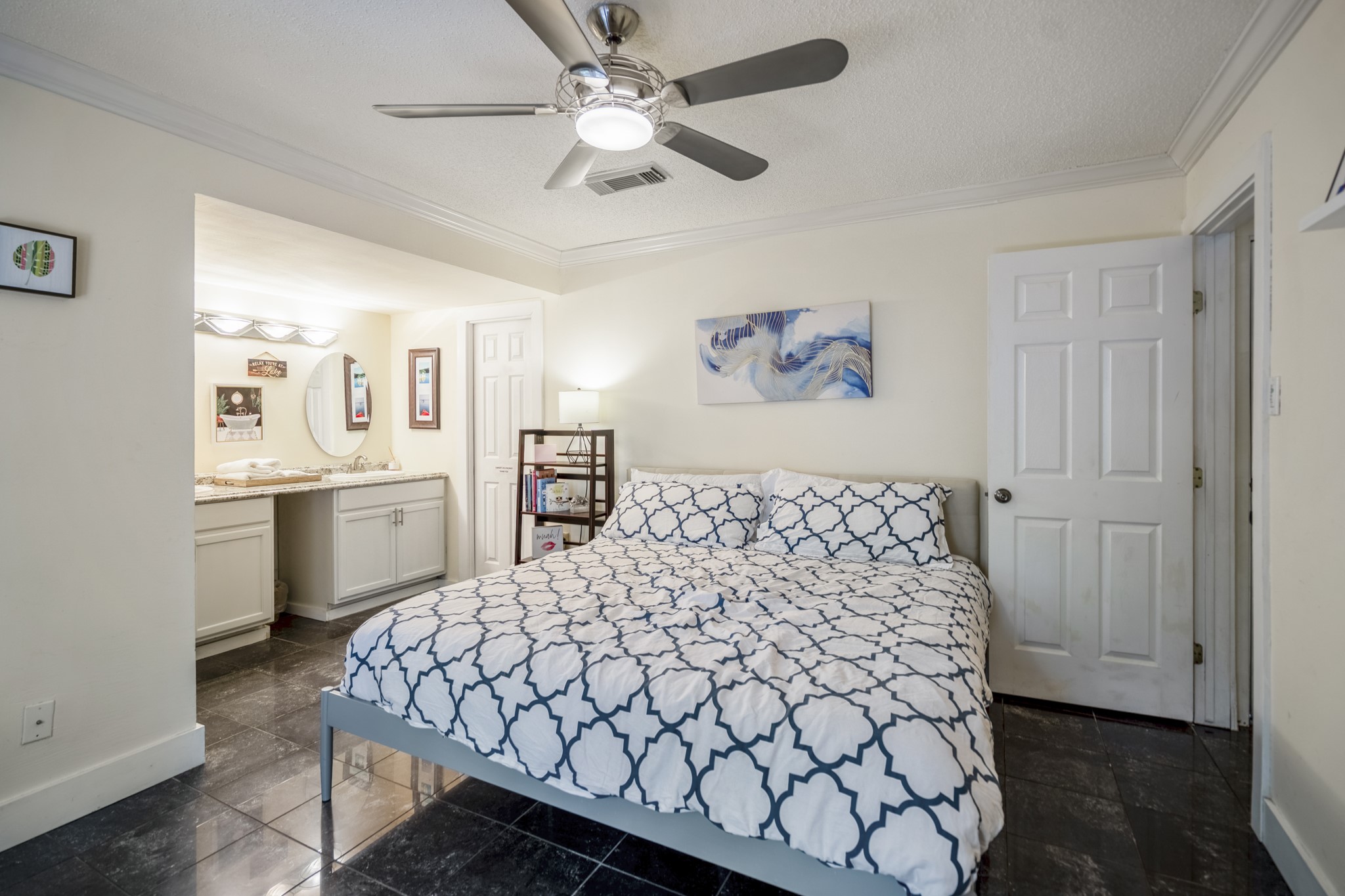 22547 Bayview Circle Point Blank, TX 77364 - Photo 25 of 46 a bedroom with a bed and a chandelier