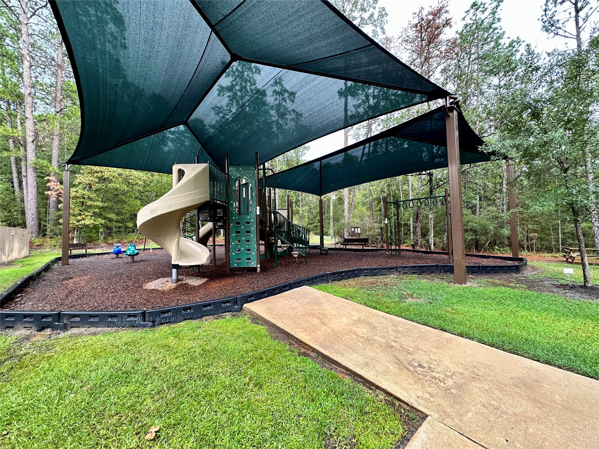 22547 Bayview Circle Point Blank, TX 77364 - Photo 44 of 46 a view of a backyard with table and chairs under an umbrella
