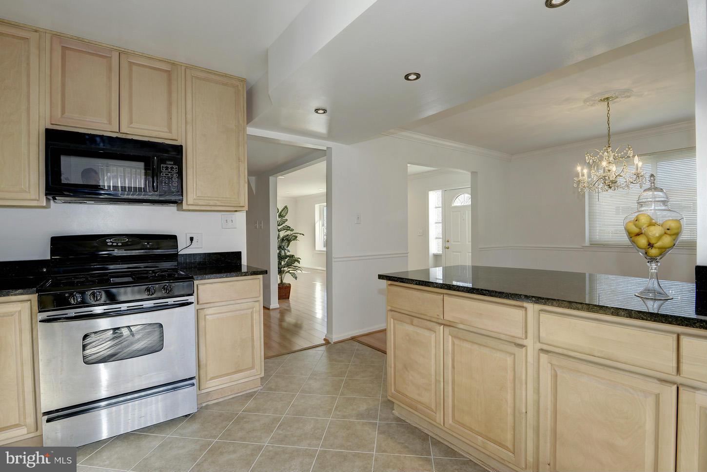 5508 Margate Street Springfield, VA 22151 - Photo 11 of 27 a kitchen with granite countertop white cabinets and stainless steel appliances