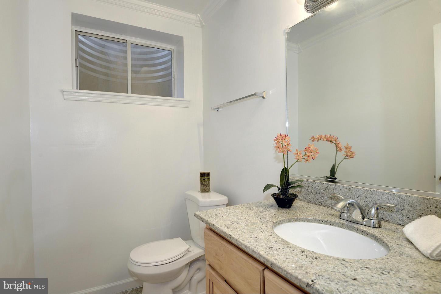 5508 Margate Street Springfield, VA 22151 - Photo 12 of 27 a bathroom with a granite countertop sink and a mirror