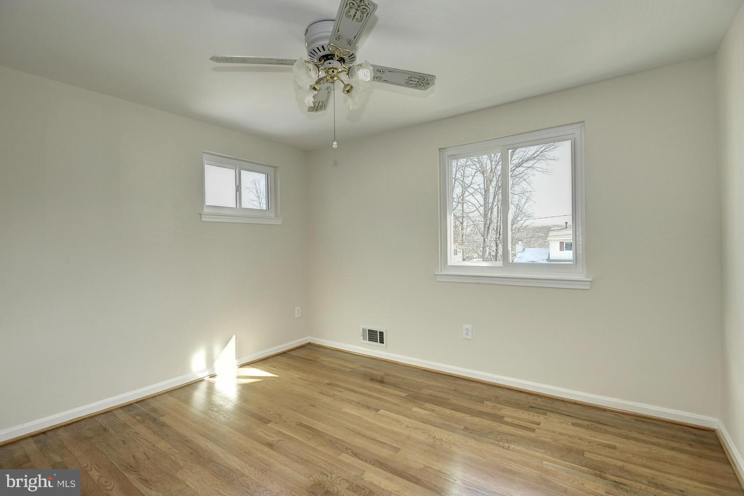 5508 Margate Street Springfield, VA 22151 - Photo 15 of 27 a view of empty room with wooden floor and fan