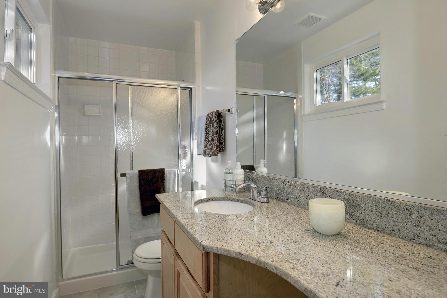 5508 Margate Street Springfield, VA 22151 - Photo 17 of 27 a bathroom with a granite countertop sink toilet and shower