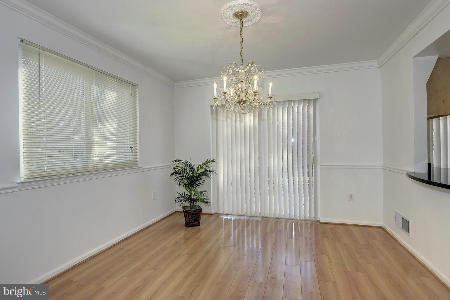 5508 Margate Street Springfield, VA 22151 - Photo 3 of 27 a view of a room with wooden floor potted plant and windows