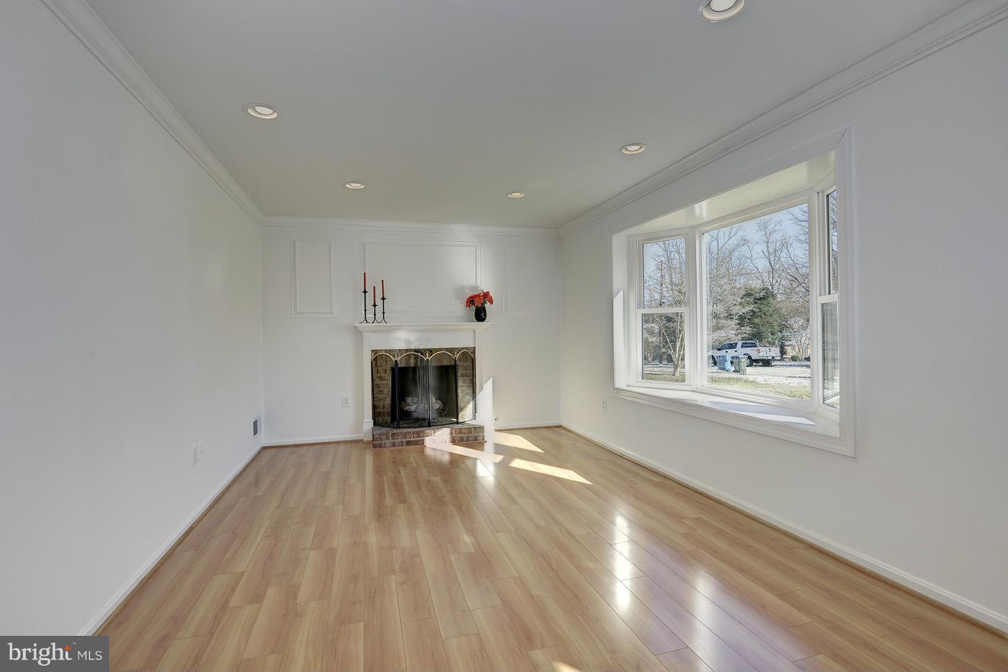5508 Margate Street Springfield, VA 22151 - Photo 4 of 27 a view of an empty room with a fireplace and a window
