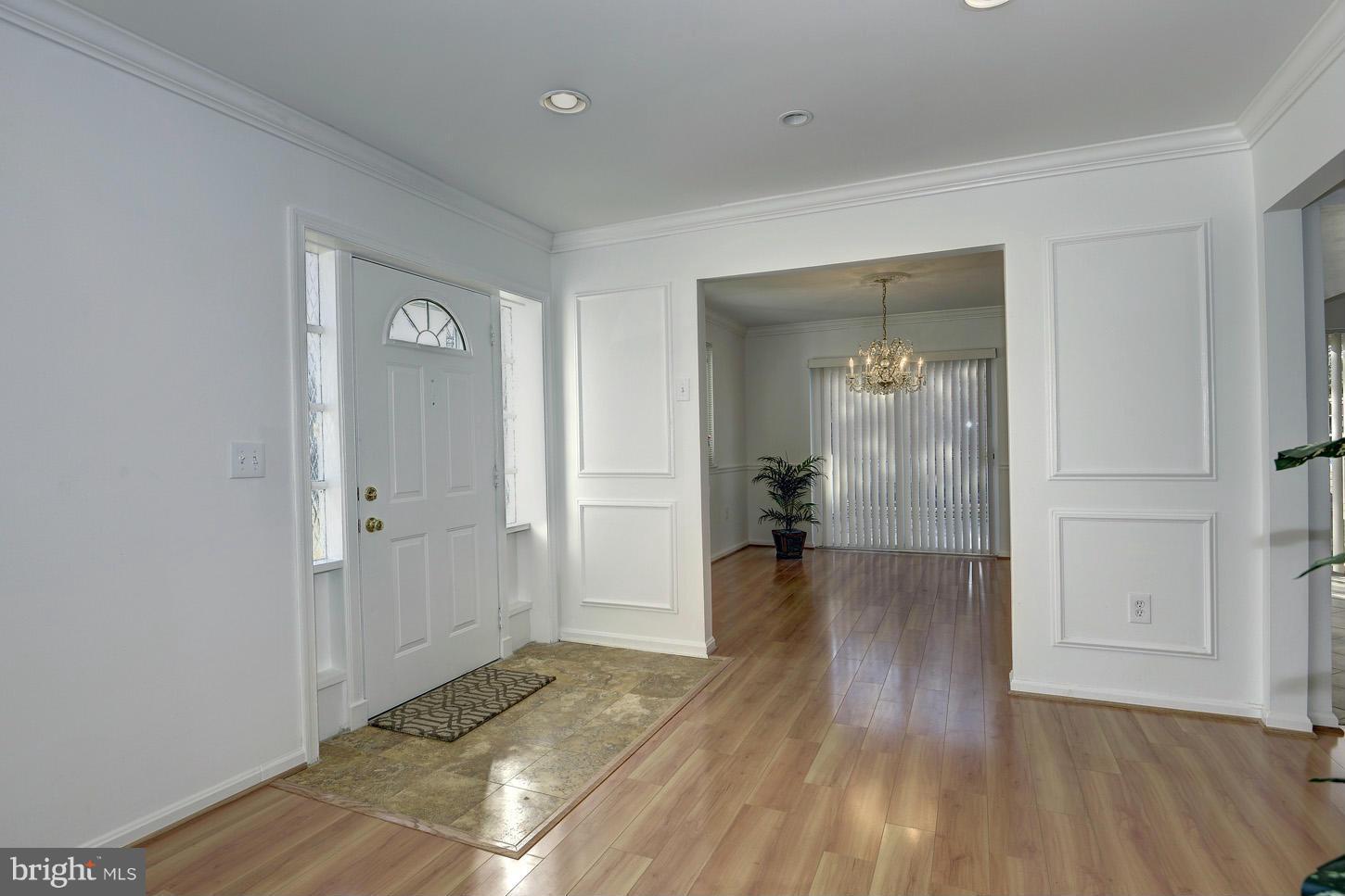 5508 Margate Street Springfield, VA 22151 - Photo 5 of 27 a view of a hallway with wooden floor and a bathroom