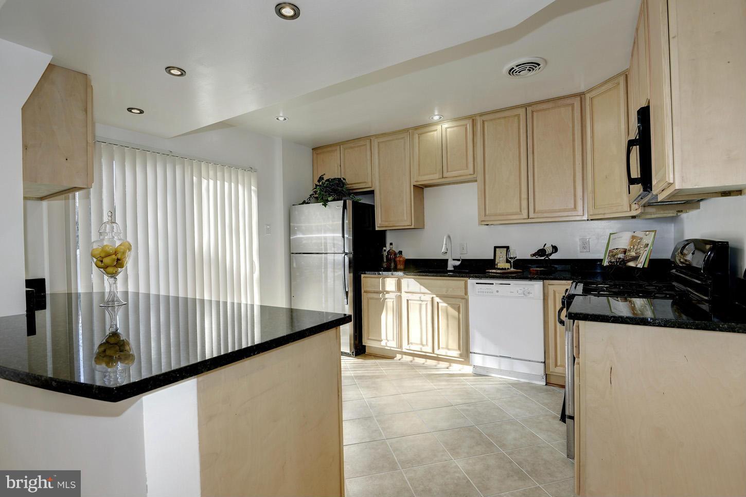 5508 Margate Street Springfield, VA 22151 - Photo 8 of 27 a kitchen with refrigerator and white cabinets