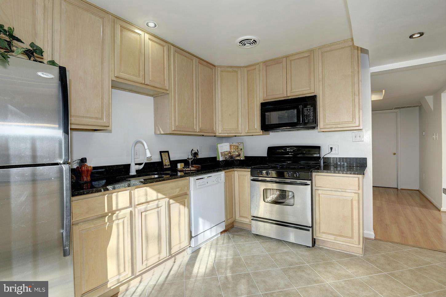 5508 Margate Street Springfield, VA 22151 - Photo 10 of 27 a kitchen with granite countertop a sink a stove top oven and refrigerator