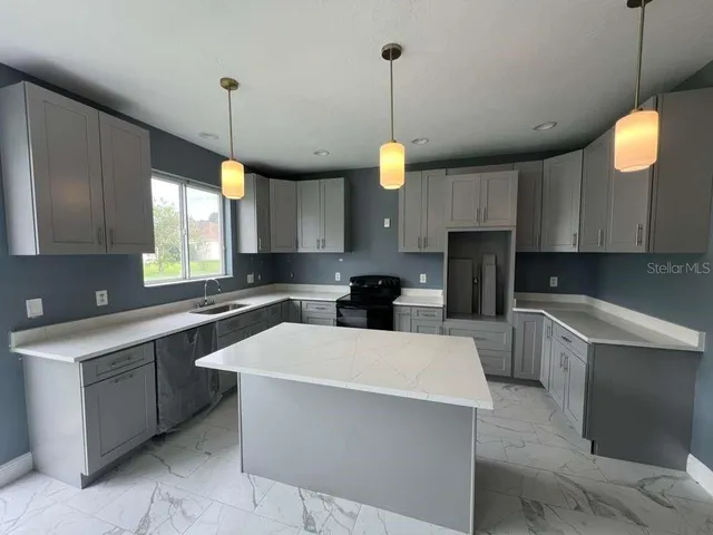 a view of a park with large trees and a yard