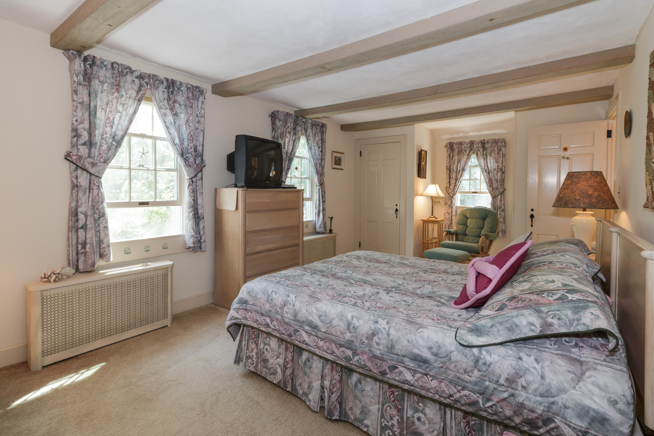 75 Harbor Bluff Road Hyannis, MA 02601 - Photo 11 of 31 a bedroom with a bed and a dresser next to a window