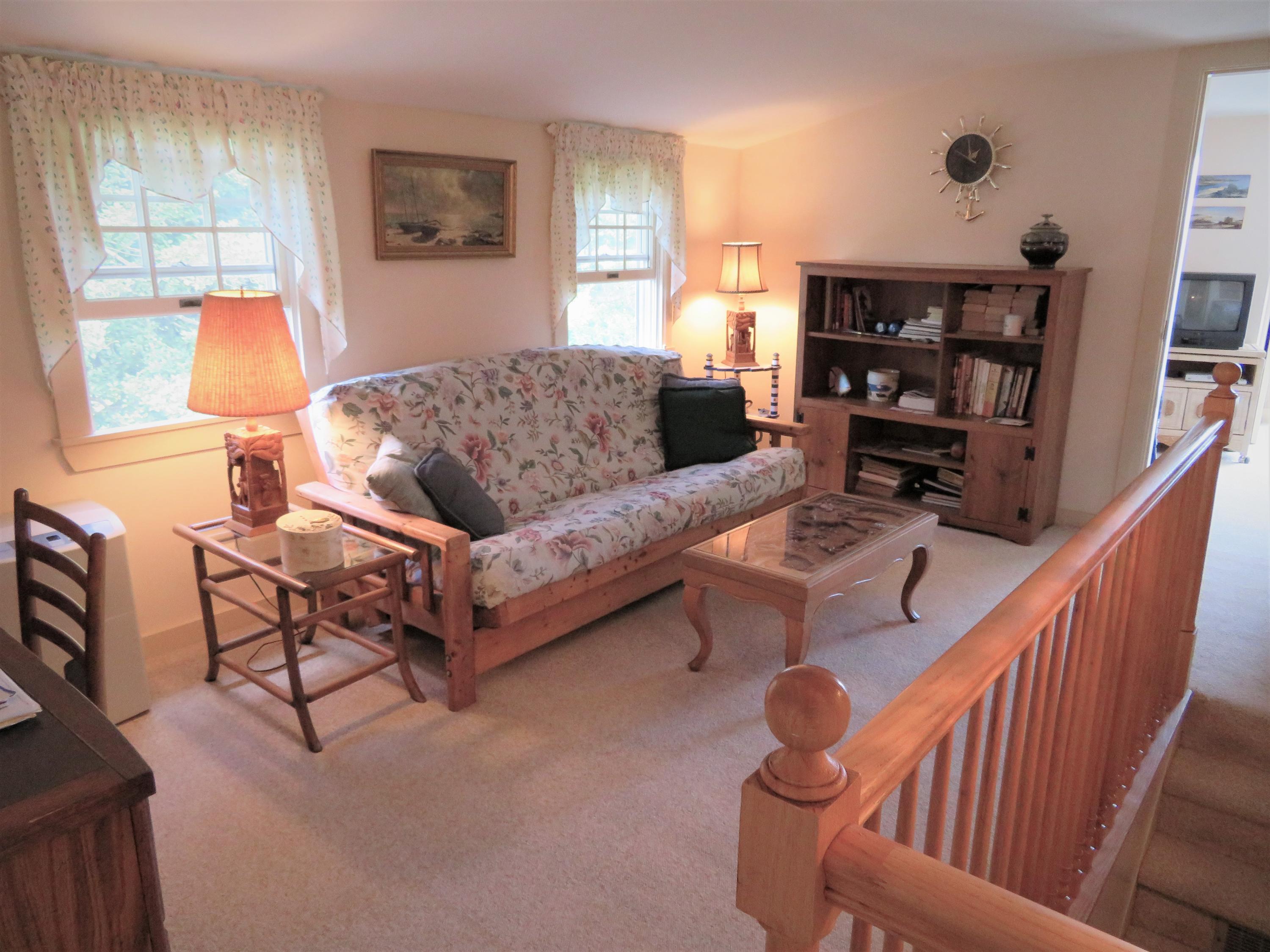 75 Harbor Bluff Road Hyannis, MA 02601 - Photo 18 of 31 a living room with furniture and a book shelf