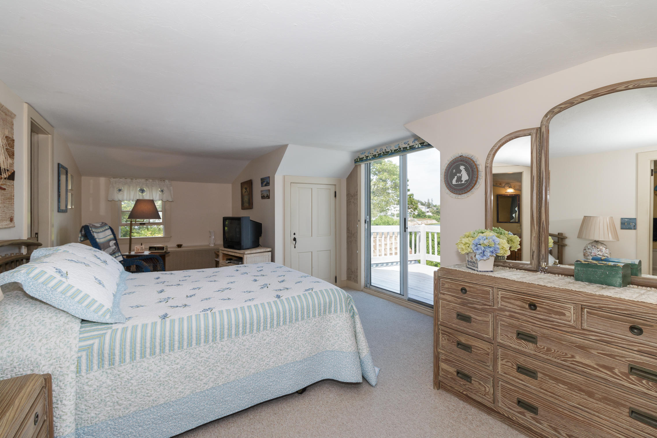 75 Harbor Bluff Road Hyannis, MA 02601 - Photo 20 of 31 a bedroom with a bed a mirror on dresser and a window