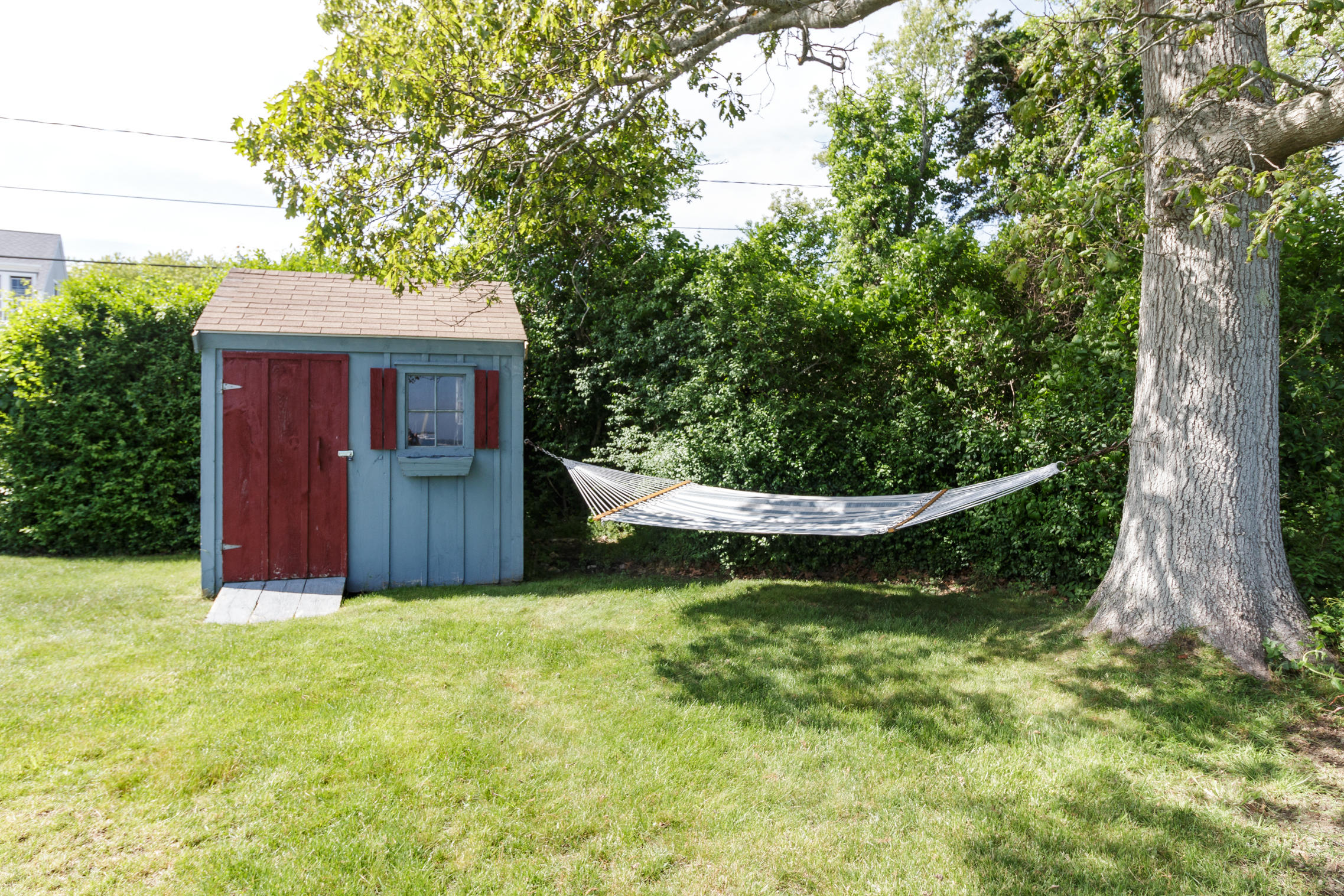 75 Harbor Bluff Road Hyannis, MA 02601 - Photo 30 of 31 a view of a backyard with large trees
