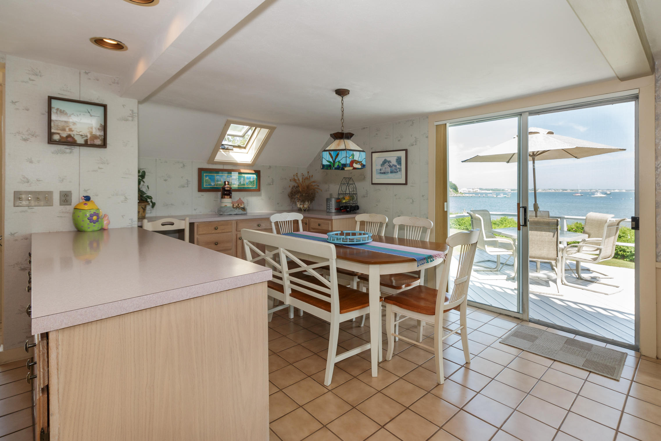 75 Harbor Bluff Road Hyannis, MA 02601 - Photo 8 of 31 a dining room that has a table and chairs in it