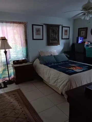 a bedroom with bed cabinet and window