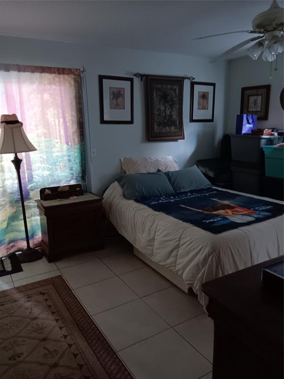 503 Saxony Drive, Unit 503 Delray Beach, FL 33446 - Photo 11 of 21 a bedroom with bed cabinet and window