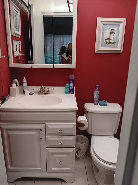 503 Saxony Drive, Unit 503 Delray Beach, FL 33446 - Photo 12 of 21 a bathroom with a toilet sink and mirror