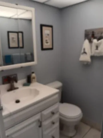 a white toilet sitting next to a bathroom sink