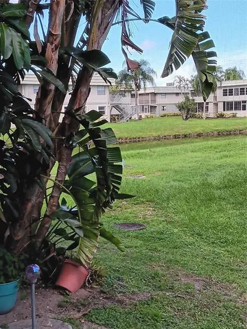 a view of a house with a backyard