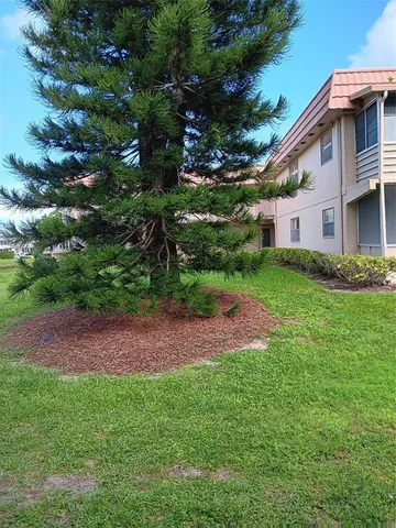 a view of backyard of house with green space