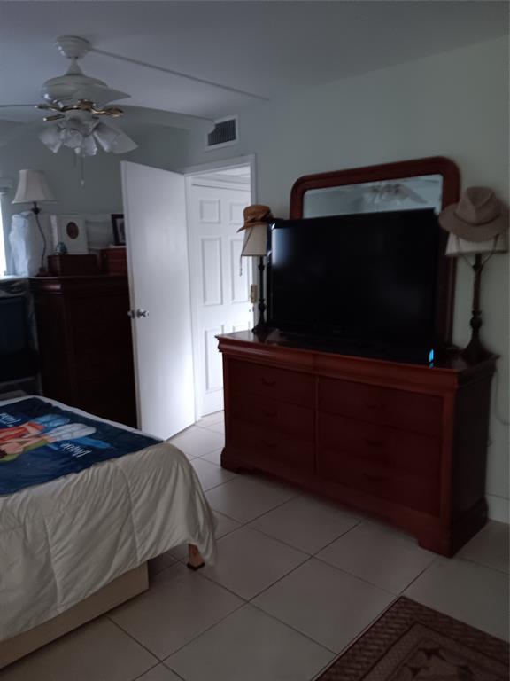 503 Saxony Drive, Unit 503 Delray Beach, FL 33446 - Photo 7 of 21 a bedroom with a bed and mirror