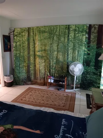 a view of a swimming pool with a patio and a yard