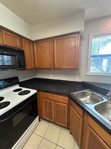 a kitchen with a sink stove top oven and cabinets