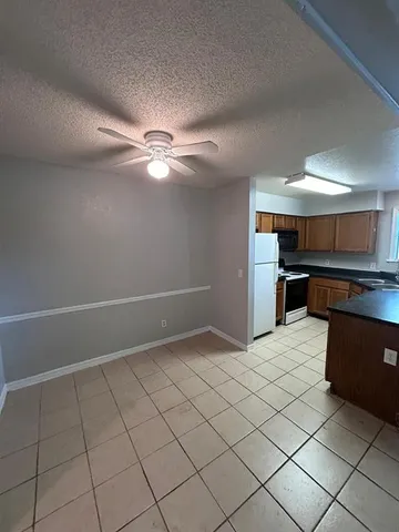a view of kitchen with microwave and cabinets