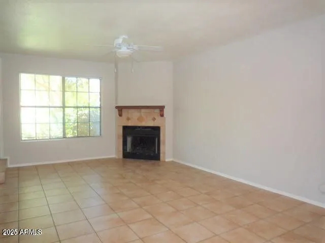 an empty room with windows and fireplace