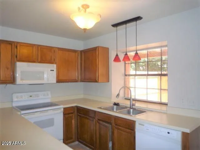 a kitchen with granite countertop a sink stainless steel appliances cabinets and a large window