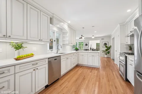 a kitchen with white cabinets and stainless steel appliances