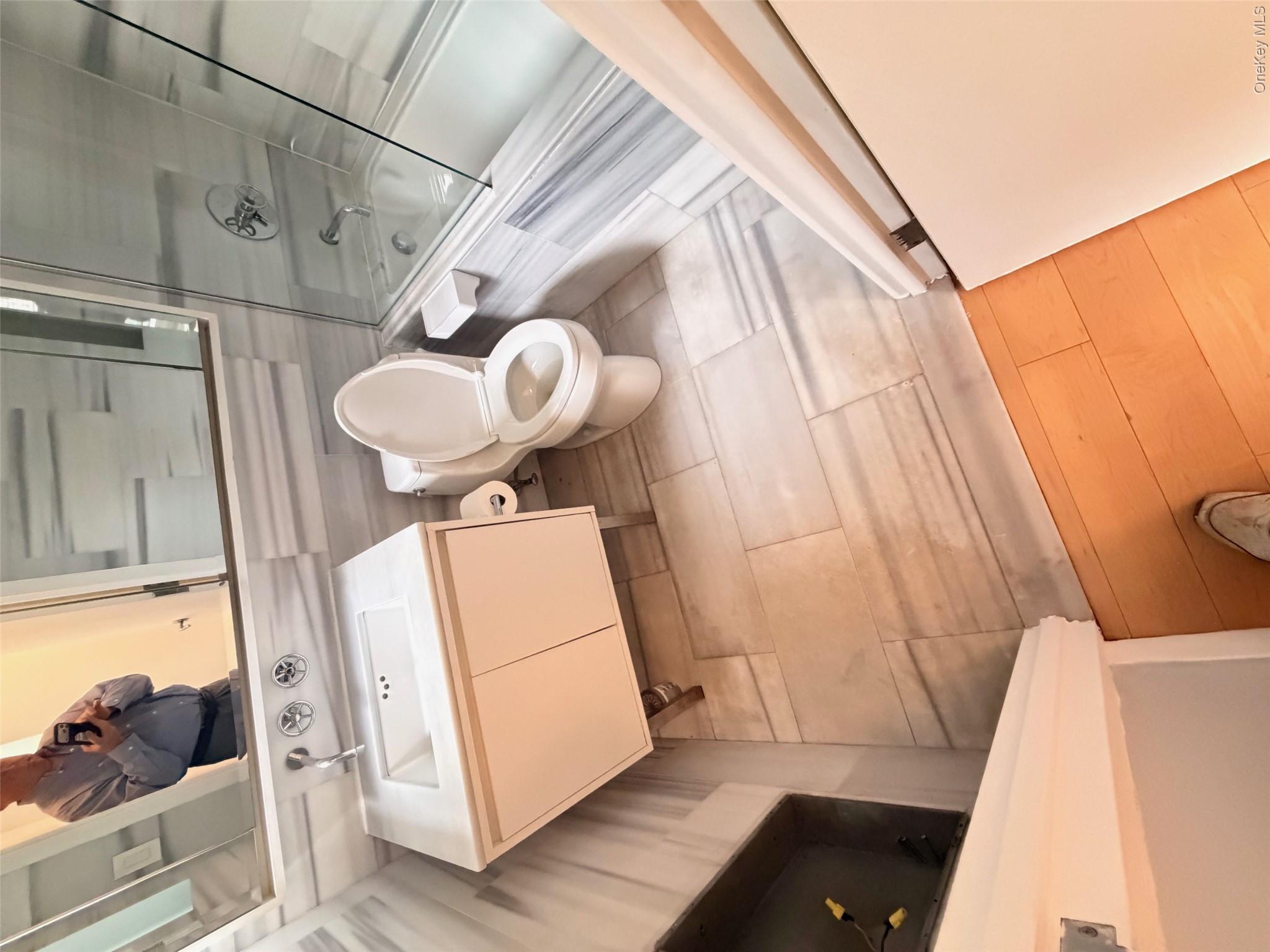 225 Rector Place, Unit 7E Manhattan, NY 10280 - Photo 13 of 19 Bathroom featuring a white vanity with an integrated sink, chrome wall-mounted faucet, and a large mirror