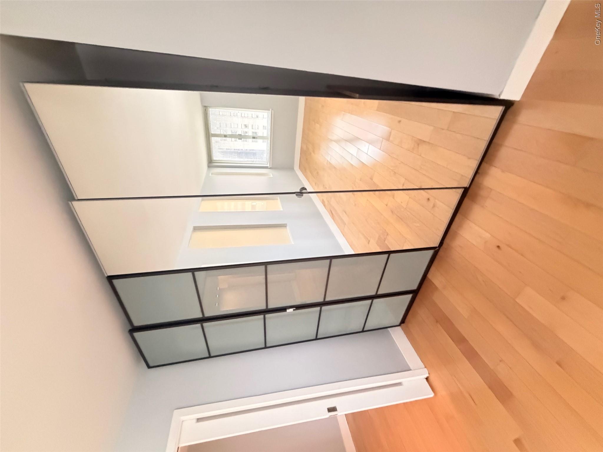 225 Rector Place, Unit 7E Manhattan, NY 10280 - Photo 7 of 19 Full-height mirrored closet doors featuring a black frame and adjacent frosted glass panels