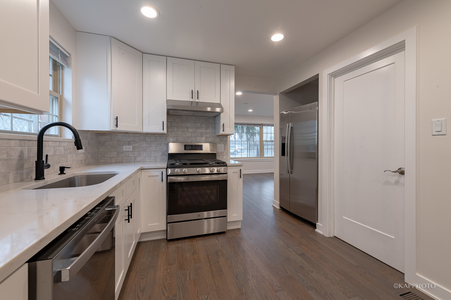 5654 South Princeton Avenue Chicago, IL 60621 - Photo 11 of 29 a kitchen with stainless steel appliances a sink cabinets and wooden floor