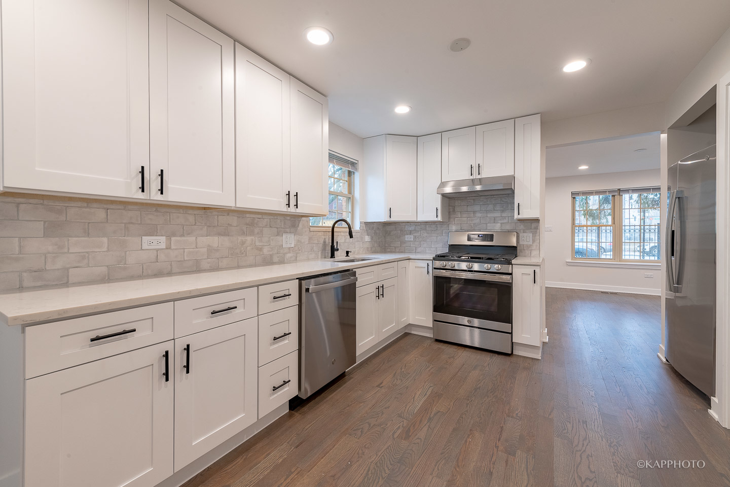 5654 South Princeton Avenue Chicago, IL 60621 - Photo 12 of 29 a kitchen with granite countertop white cabinets and white appliances