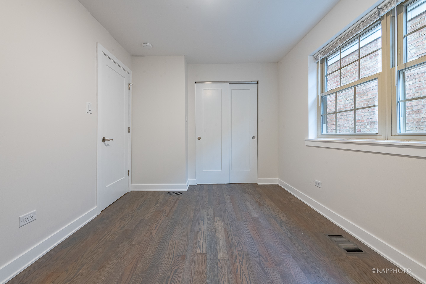 5654 South Princeton Avenue Chicago, IL 60621 - Photo 16 of 29 an empty room with wooden floor and windows