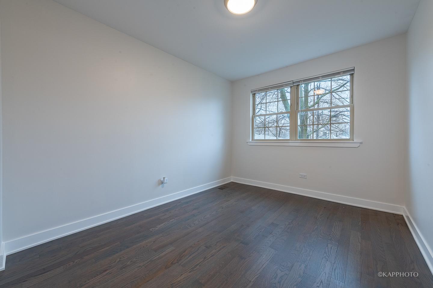 5654 South Princeton Avenue Chicago, IL 60621 - Photo 17 of 29 an empty room with wooden floor and windows